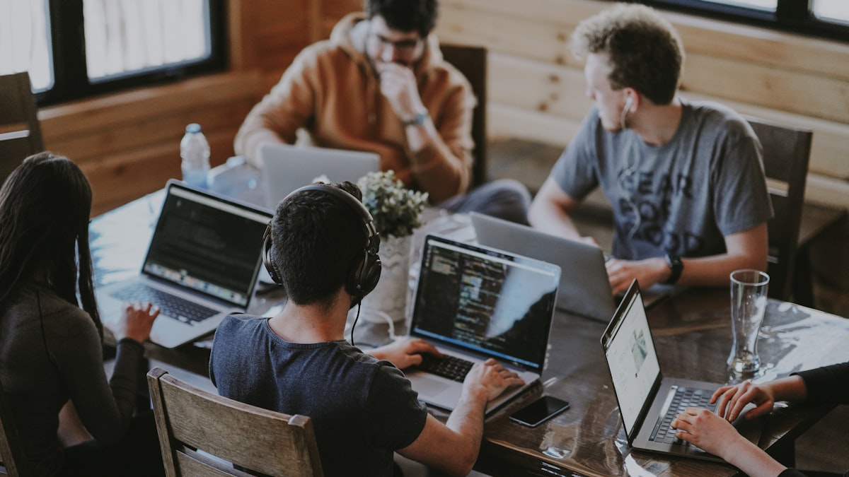 A small software team working at desks in an open-plan office