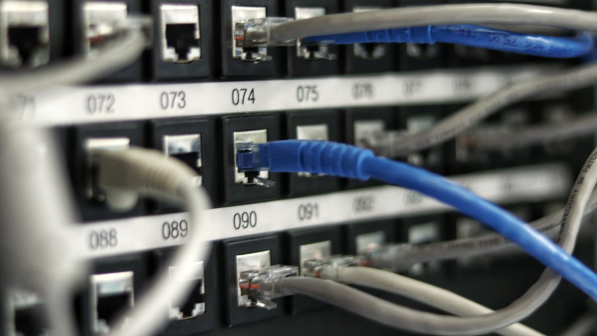 Network operations centre with wall screens showing traffic