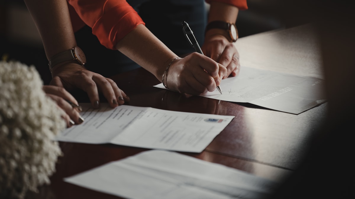 Signing an offer letter with equity terms at an office desk