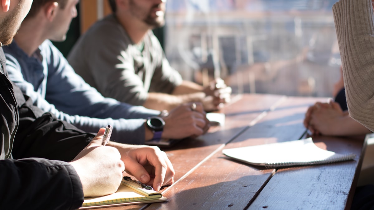 Startup founders reviewing paperwork on a laptop in a small office