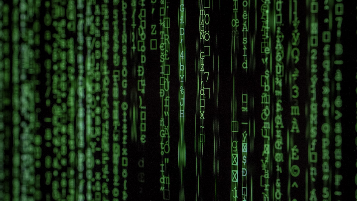 A security analyst inspecting code on a computer screen