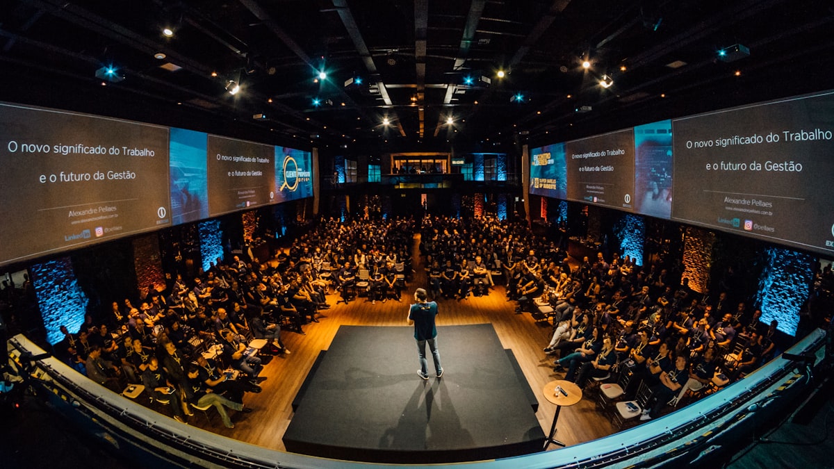 A founder presenting to a seated audience at a startup event